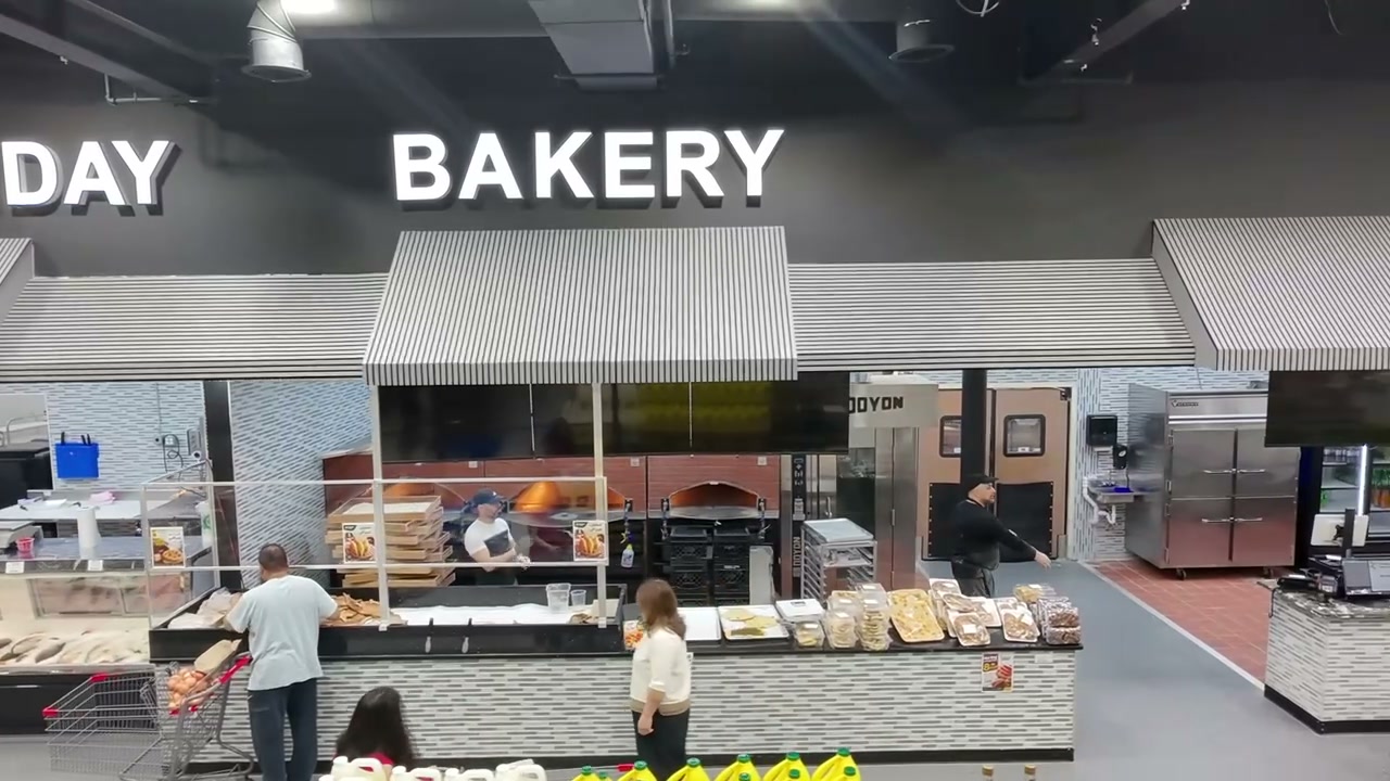 In-store Lemona bakery with wood-fired ovens and fresh breads on display.